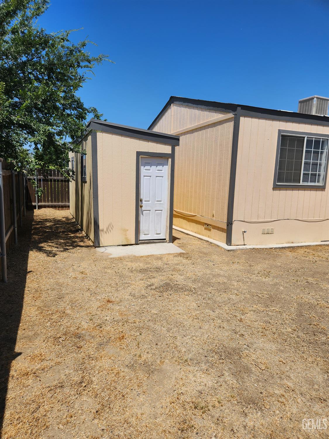 Undisclosed Address Bakersfield, CA 93314 - Photo 25 of 28 a view of a backyard with wooden fence