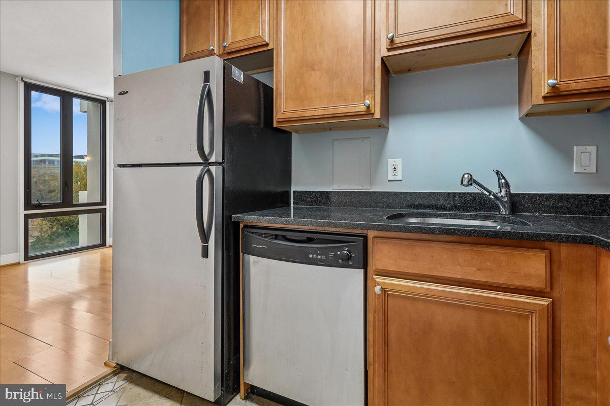 1245 4th Street Southwest, Unit E409 Washington, DC 20024 - Photo 11 of 21 a kitchen with stainless steel appliances granite countertop a refrigerator and a sink