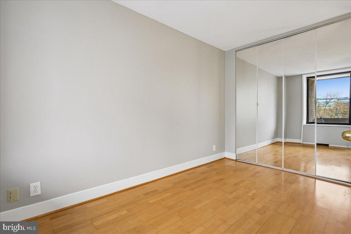 1245 4th Street Southwest, Unit E409 Washington, DC 20024 - Photo 16 of 21 a view of empty room with wooden floor and fan