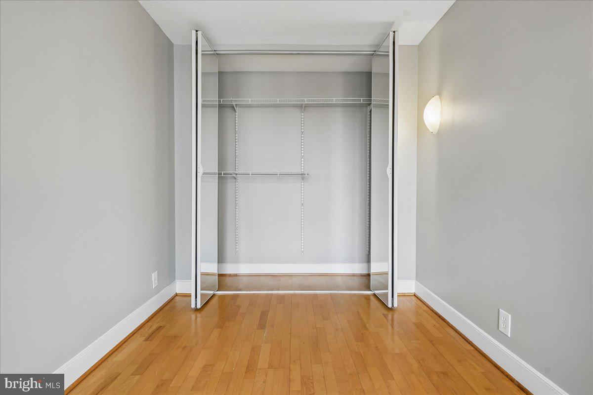 1245 4th Street Southwest, Unit E409 Washington, DC 20024 - Photo 19 of 21 a view of an empty room with wooden floor