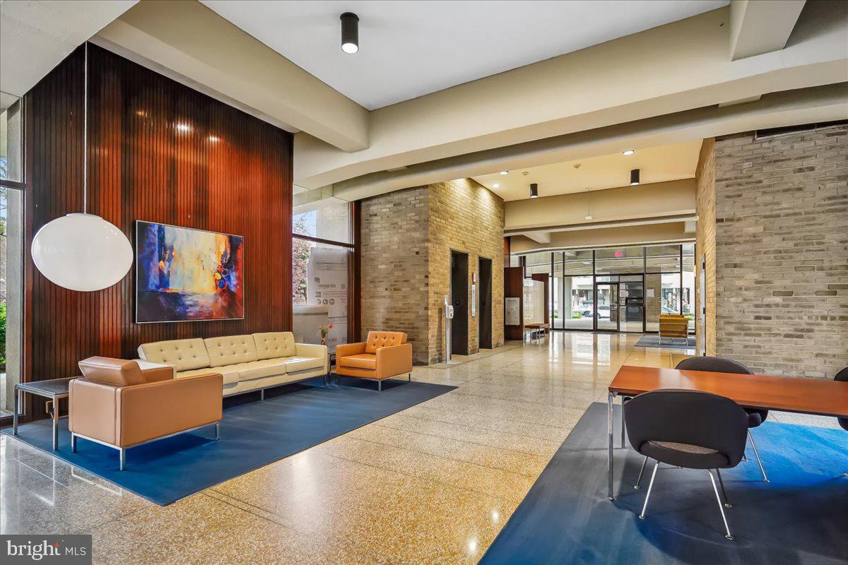 1245 4th Street Southwest, Unit E409 Washington, DC 20024 - Photo 2 of 21 a living room with furniture and a large window
