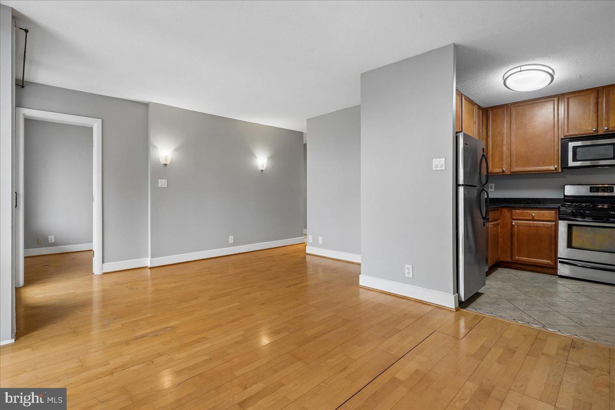 1245 4th Street Southwest, Unit E409 Washington, DC 20024 - Photo 5 of 21 a view of a kitchen with a sink and a refrigerator