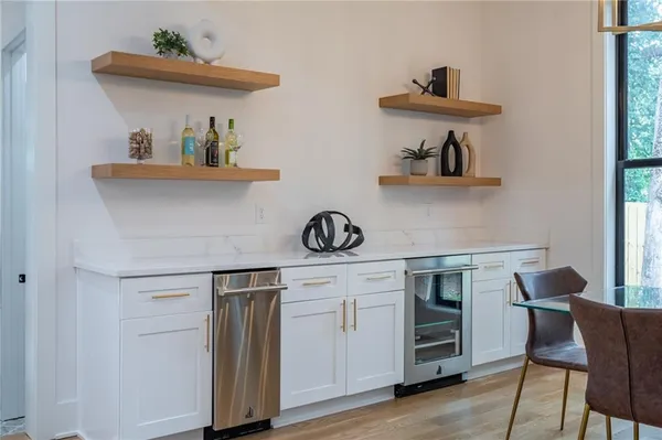 a kitchen with stainless steel appliances granite countertop a sink and wooden cabinets