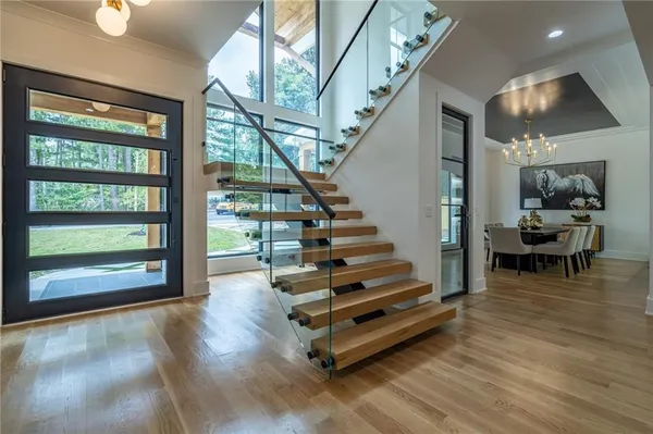 a view of entryway and hall with wooden floor