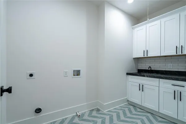 a view of a kitchen with white cabinets