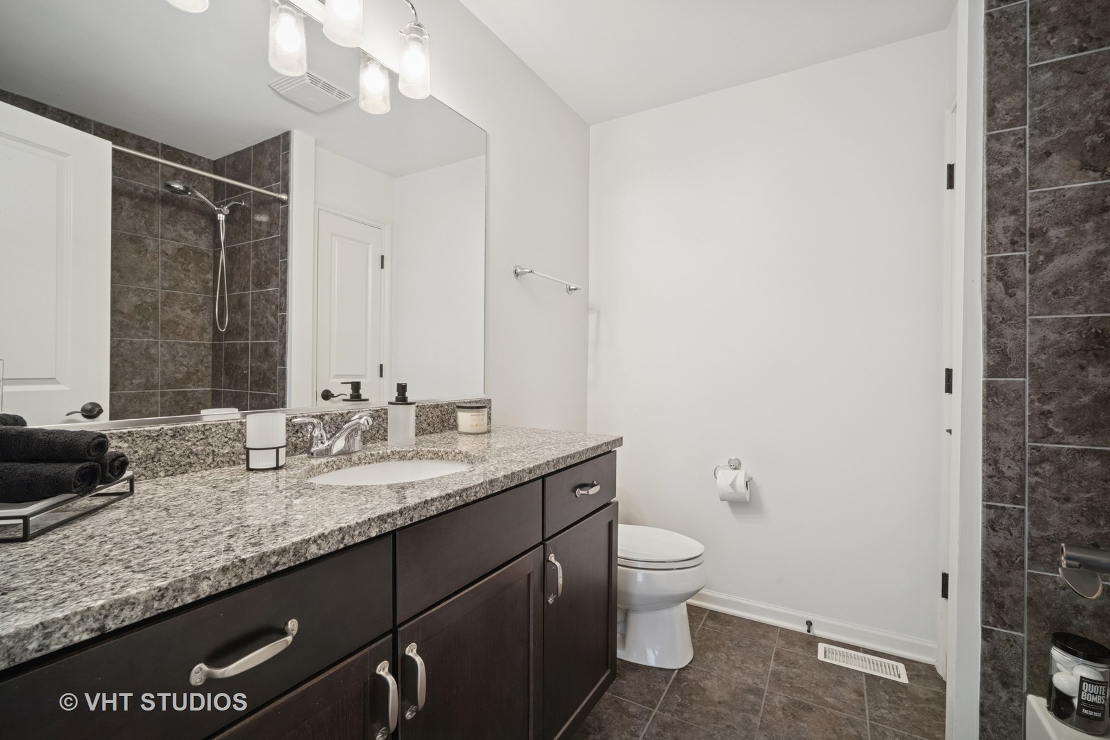 1981 Dauntless Drive Glenview, IL 60026 - Photo 20 of 43 a bathroom with a granite countertop sink a toilet and a mirror
