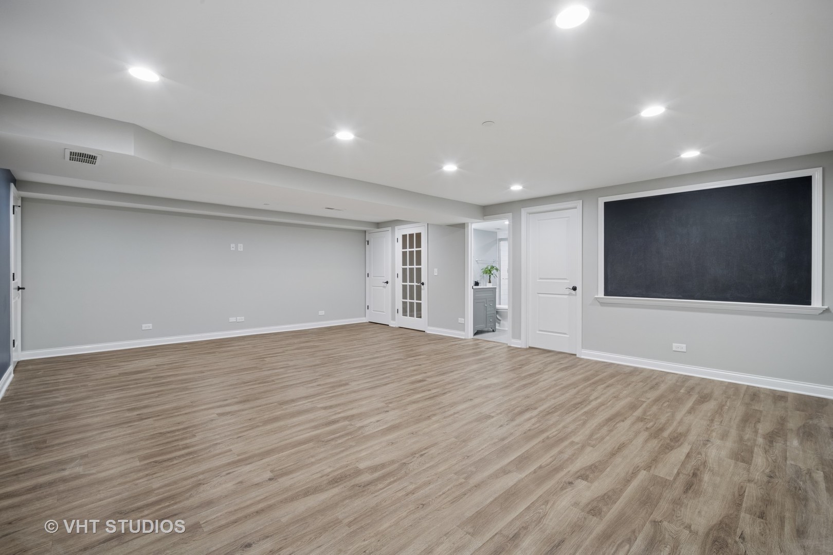 1981 Dauntless Drive Glenview, IL 60026 - Photo 35 of 43 a view of an empty room with wooden floor and kitchen space