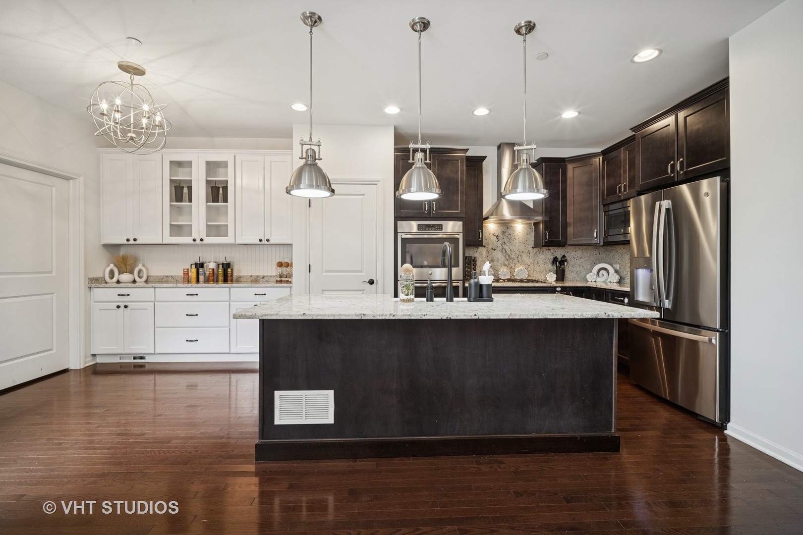 1981 Dauntless Drive Glenview, IL 60026 - Photo 9 of 43 a kitchen with stainless steel appliances granite countertop a refrigerator a sink dishwasher a stove and white cabinets with wooden floor