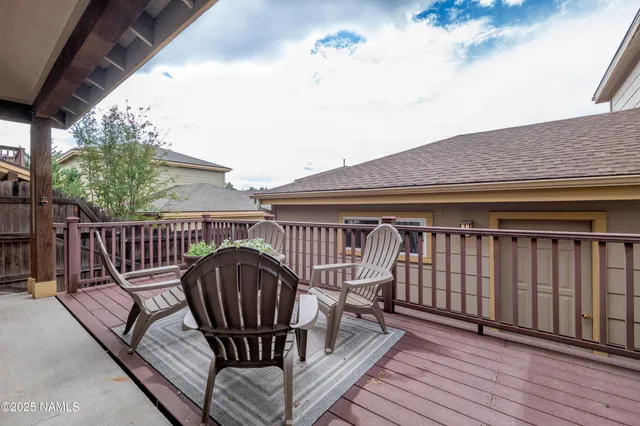 a view of balcony with wooden floor and outdoor seating