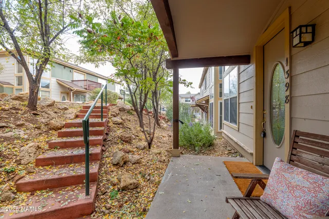 a view of a chairs and table in the backyard