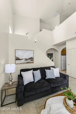 a living room with furniture and a lamp