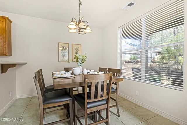 a view of a dining room with furniture and window