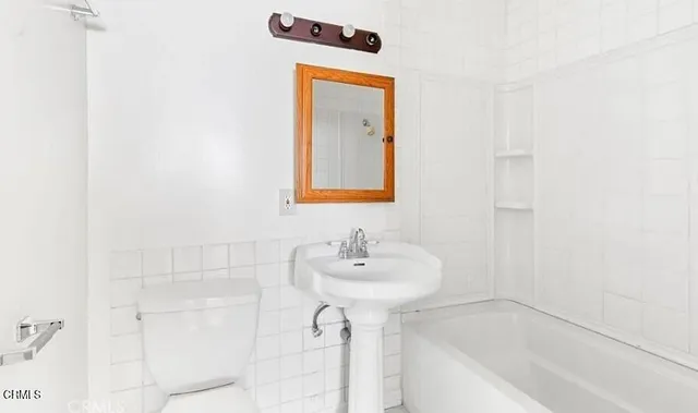 a bathroom with a sink a mirror and shower