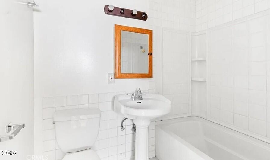 356 East Kettering Street Lancaster, CA 93535 - Photo 11 of 14 a bathroom with a sink a mirror and shower