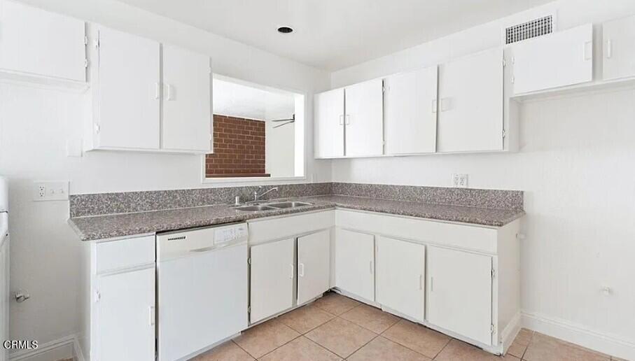 356 East Kettering Street Lancaster, CA 93535 - Photo 4 of 14 a kitchen with granite countertop white cabinets and a sink