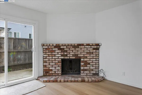 an empty room with a fireplace and window
