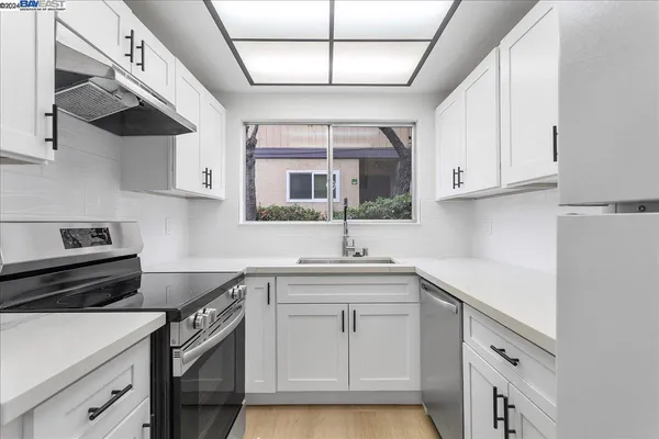 a kitchen with cabinets and appliances