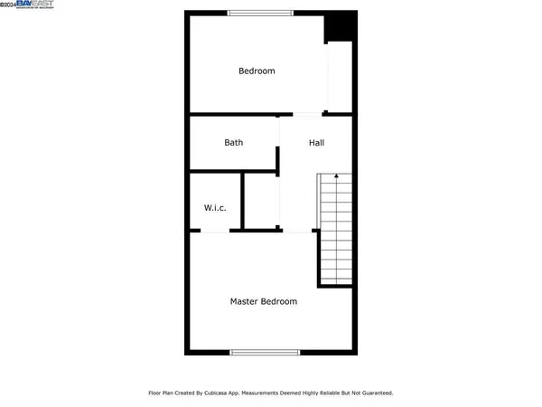 a picture of a bench in front of a wall