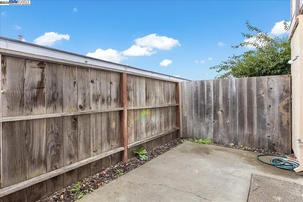 a view of a hallway with wooden floor and a bathroom