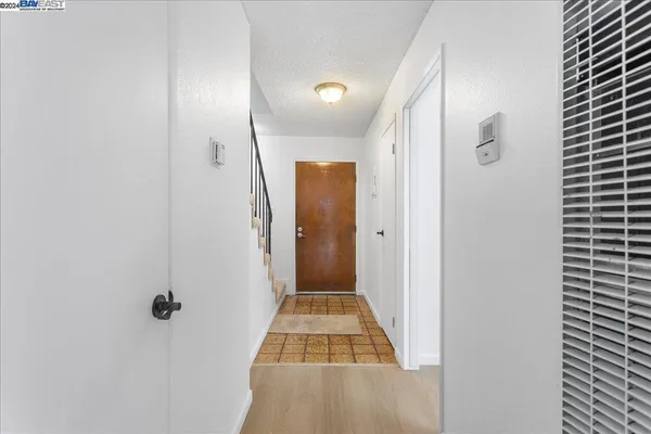 a view of a hallway with a glass door shower