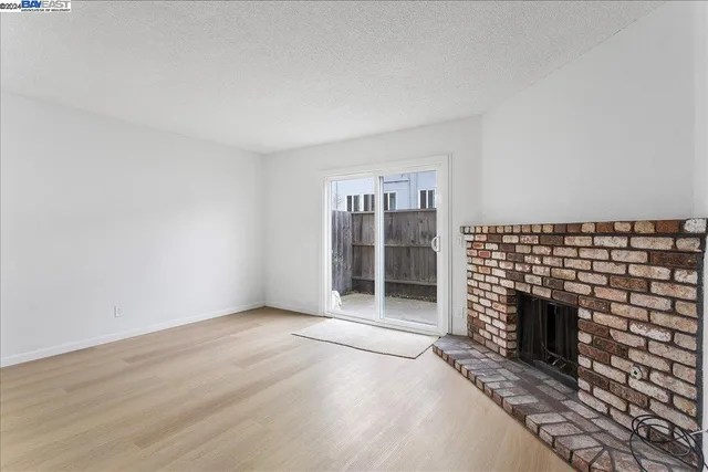 a view of fireplace and wooden floor