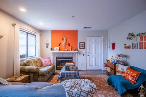 a living room with furniture a rug and a fireplace