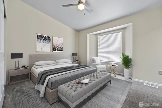 a bedroom with a large bed and a chandelier