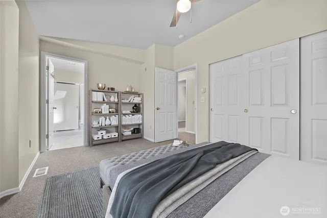 a spacious bedroom with a bed and a walk in closet