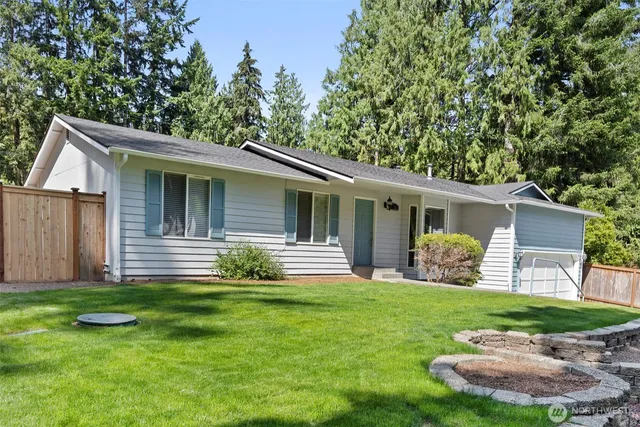 a view of a house with a yard and a garden