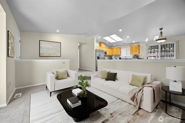 a living room with furniture rug and window