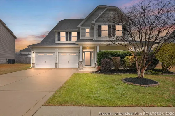 a front view of a house with a yard garage and outdoor seating