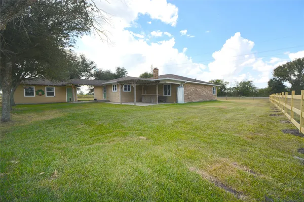 a view of a house with a yard and sitting area
