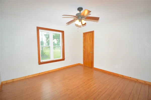 a view of a room with a ceiling fan and a window