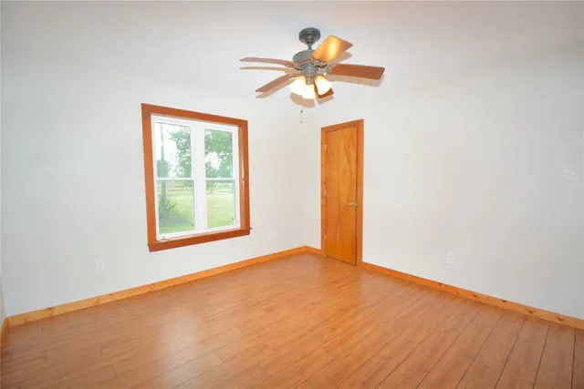a view of a room with a ceiling fan and a window