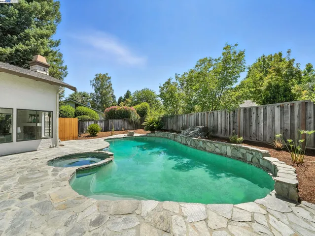 a backyard of a house with table and chairs