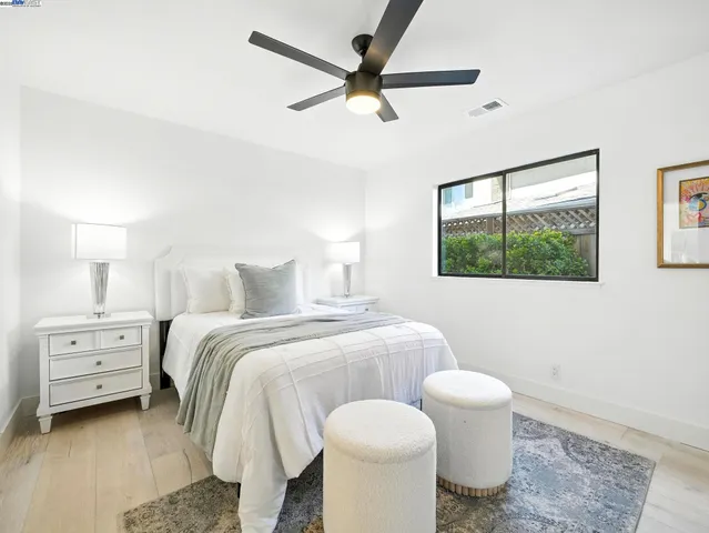 a spacious bedroom with a bed and a window