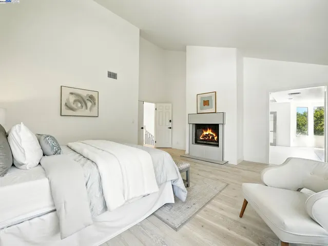 a spacious bedroom with a bed and a couch