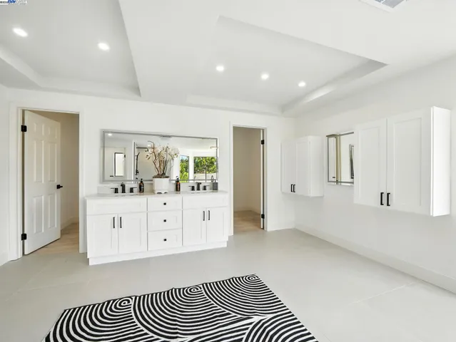 a spacious bathroom with a mirror and a bathtub