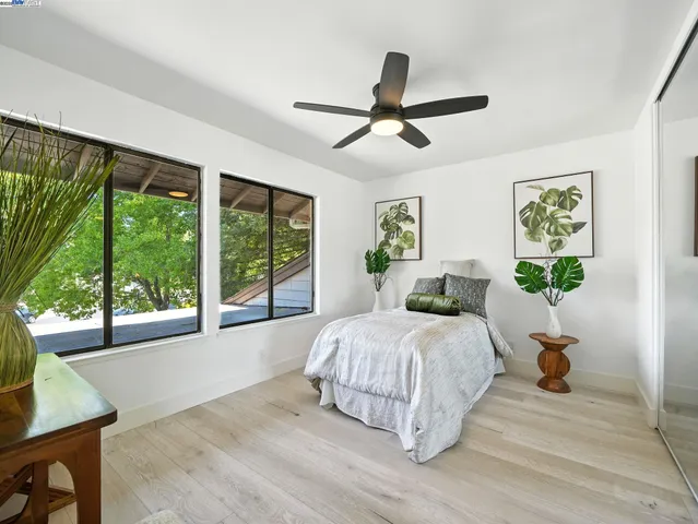 a bedroom with a large bed and a large window
