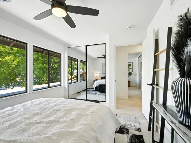 a bedroom with furniture and a large window