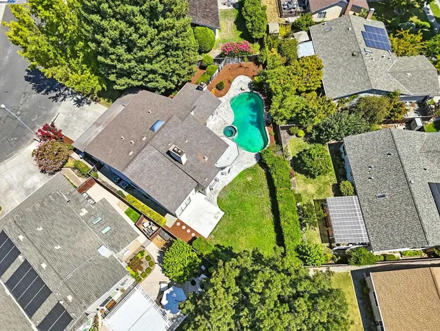 an aerial view of a house with a yard