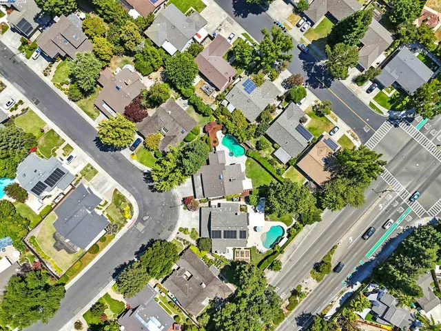an aerial view of residential houses with outdoor space
