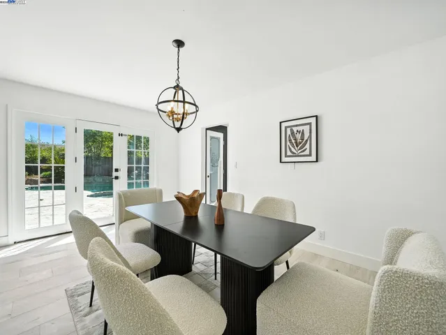 a view of a dining room with furniture wooden floor and a chandelier