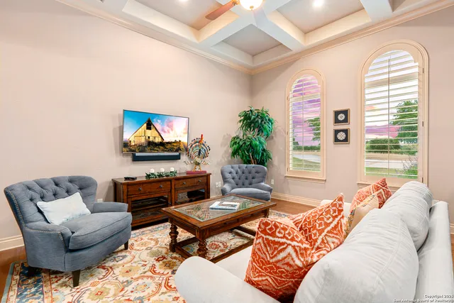 a spacious bedroom with a bed and a chandelier