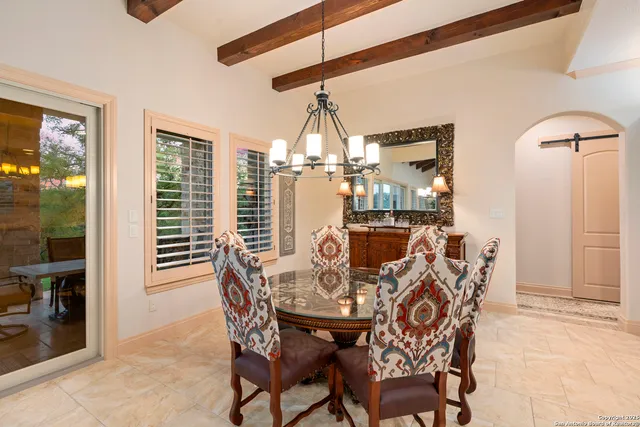 a large kitchen with stainless steel appliances granite countertop a sink dishwasher stove and refrigerator with wooden floor