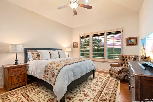 a bedroom with bed and flat screen tv