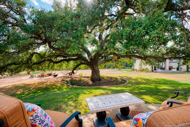 a view of yard with swimming pool and green space