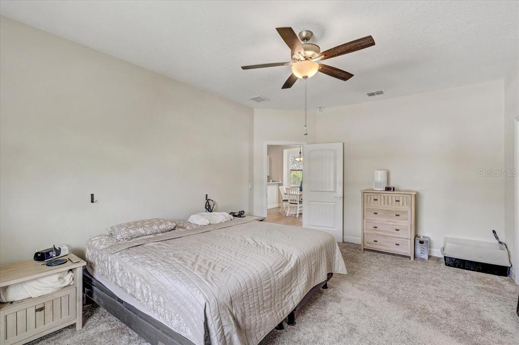 7314 Madrid Road Weeki Wachee, FL 34613 - Photo 18 of 54 a bedroom with a bed and a ceiling fan