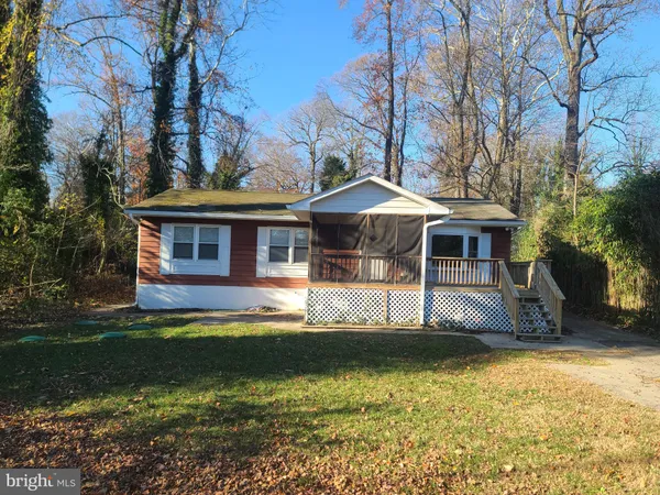 a front view of a house with a yard table and chairs