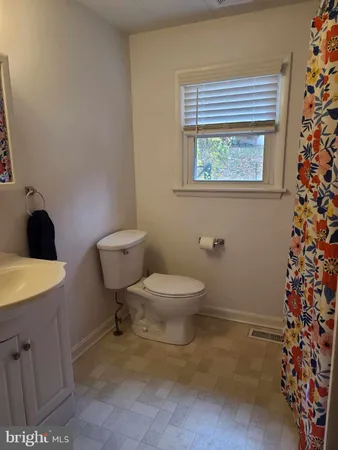 a bathroom with a toilet a sink and a shower